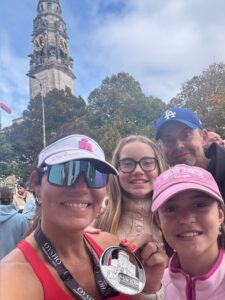 Ros Drake celebrates completing the Cardiff Half Marathon with her family. 